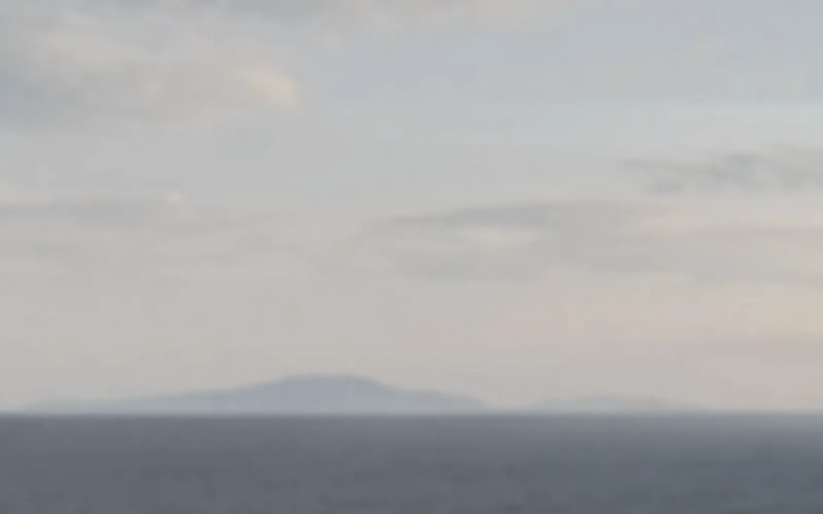 A soft, blurred patch of sky and sea: a placeholder picture.